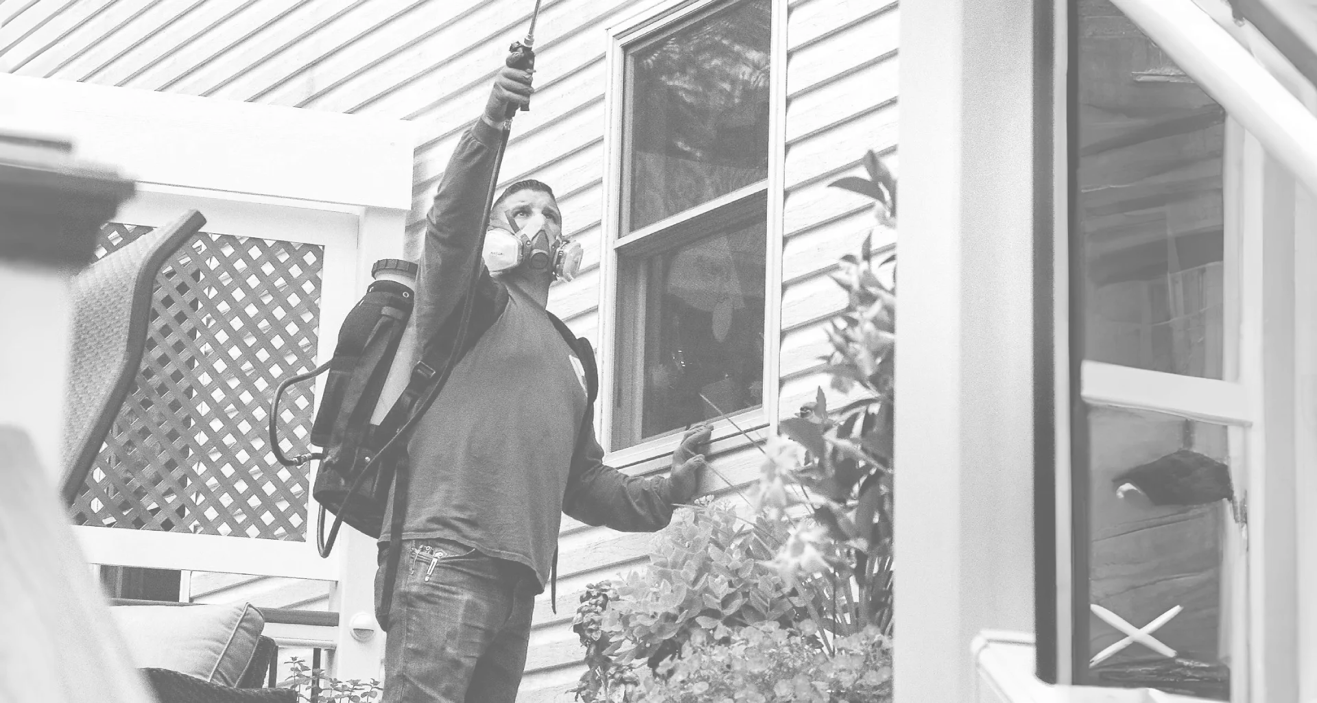Rob Jordan, owner of Bustabug, sprays a house for pest protection